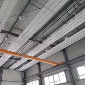 KIT radiant panels suspended in an industrial hall with large doors